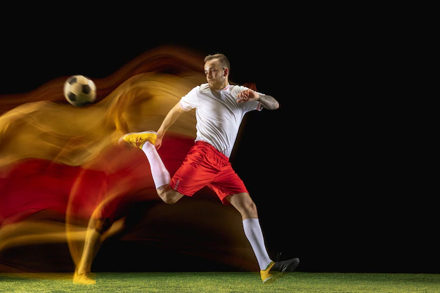 young-caucasian-male-football-soccer-player-sportwear-boots-kicking-ball-goal-mixed-light-dark-wall-concept-healthy-lifestyle-professional-sport-hobby_155003-38685